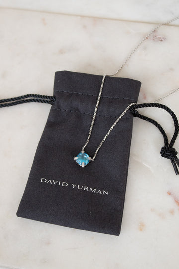 David Yurman necklace with blue gemstone on a branded pouch
