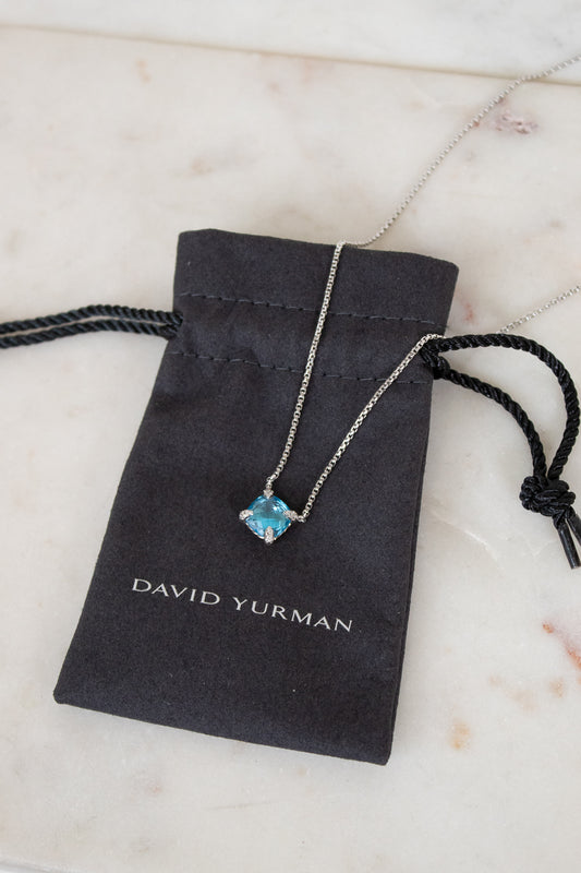 David Yurman necklace with blue gemstone on a branded pouch
