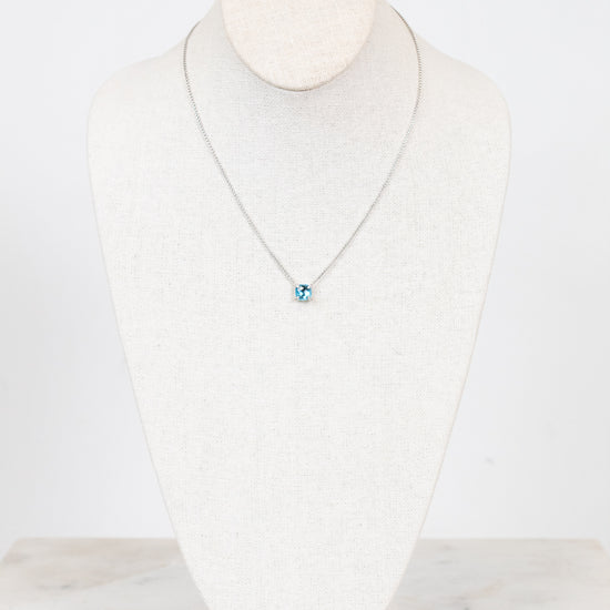 Necklace with a blue center detail on a mannequin against a white background
