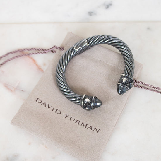 Silver bracelet on a David Yurman card with marble background