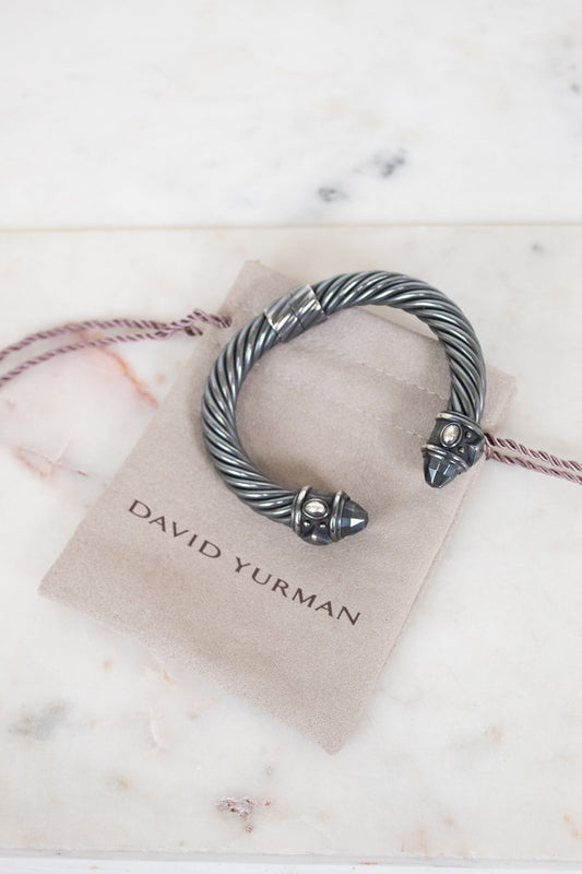 Silver bracelet on a David Yurman card with marble background