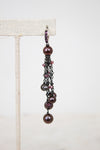 Pair of dangling pearl earrings on a white background