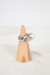 Ring on a wooden cone with a white background