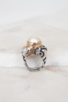Ring with pearl detail on a marble surface