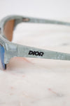 Sunglasses with Dior logo on a marble surface