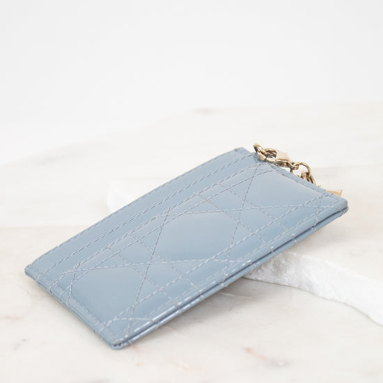 Light blue quilted card holder on a white marble surface