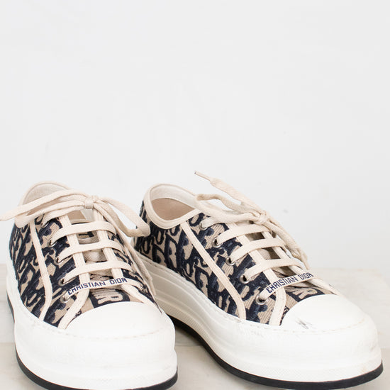 White sneakers with navy and white pattern on a light gray background