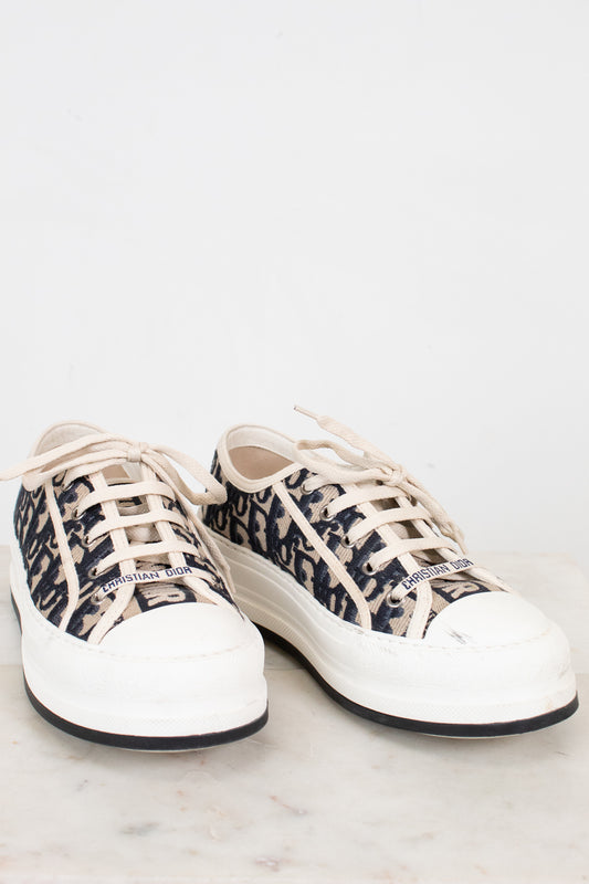 White sneakers with navy and white pattern on a light gray background