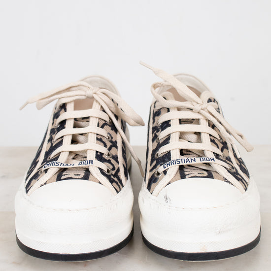 White sneakers with navy and white patterned accents on a light background