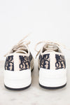 White sneakers with navy text on a white background