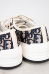 White sneakers with navy text pattern on a white background