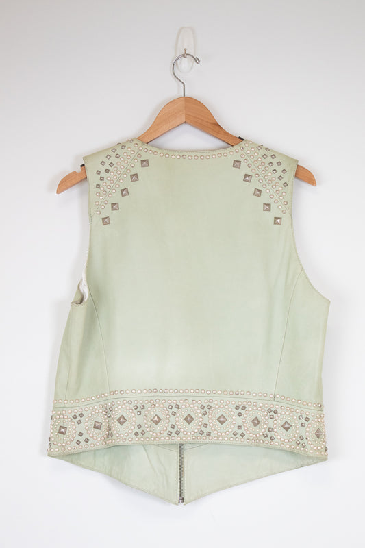 Light green sleeveless top with intricate patterns on a white background