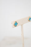 Gold earrings with turquoise and gold accents on a white background