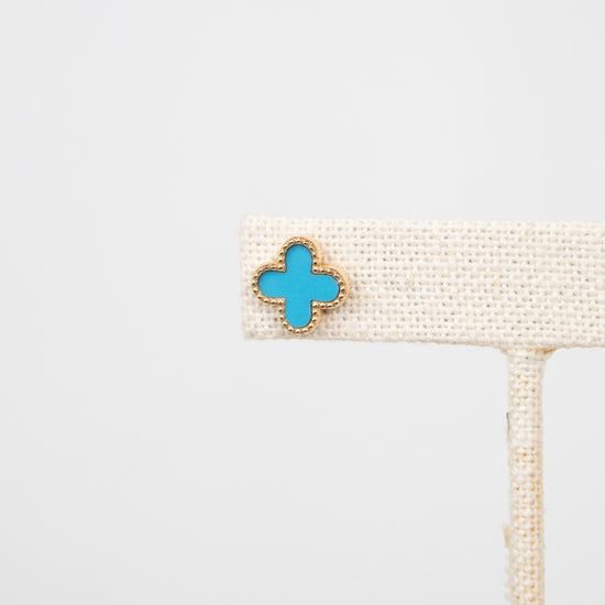 Turquoise floral shaped earring on a white background