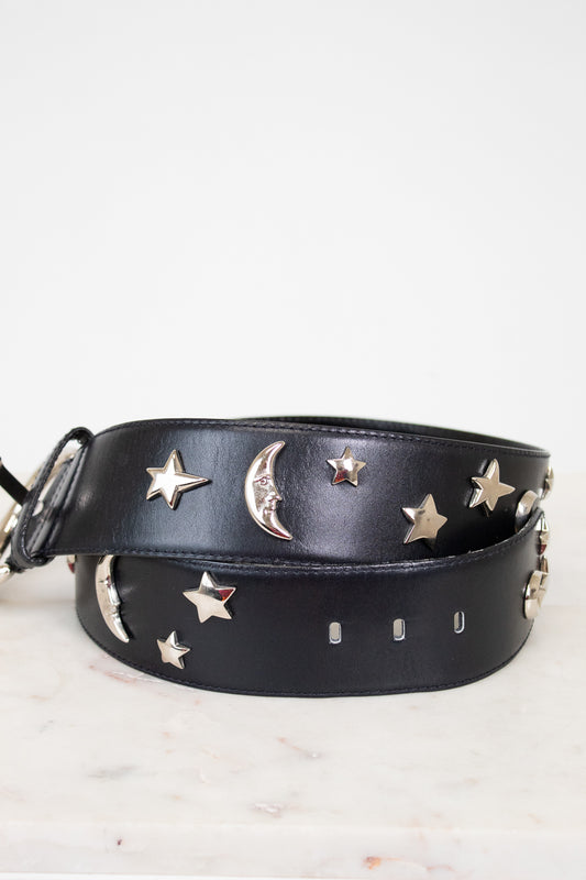 Black leather belt with star and moon embellishments on a white background