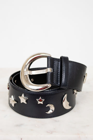 Black belt with silver buckle and star and moon embellishments on a white background