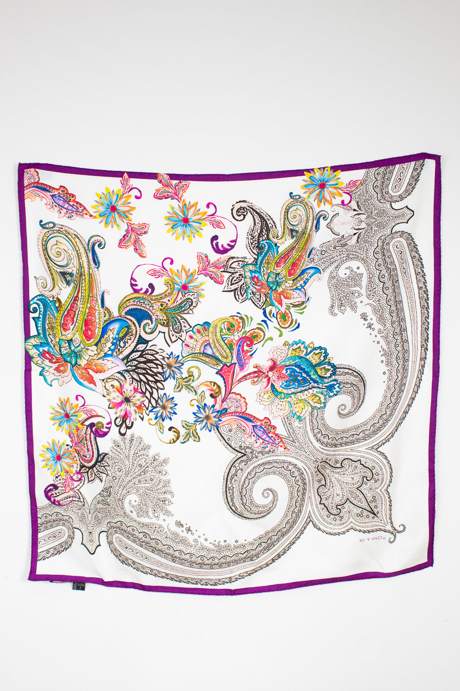 Colorful paisley patterned scarf on a white background