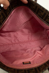 Close-up of a pink interior of a handbag with a brand logo.