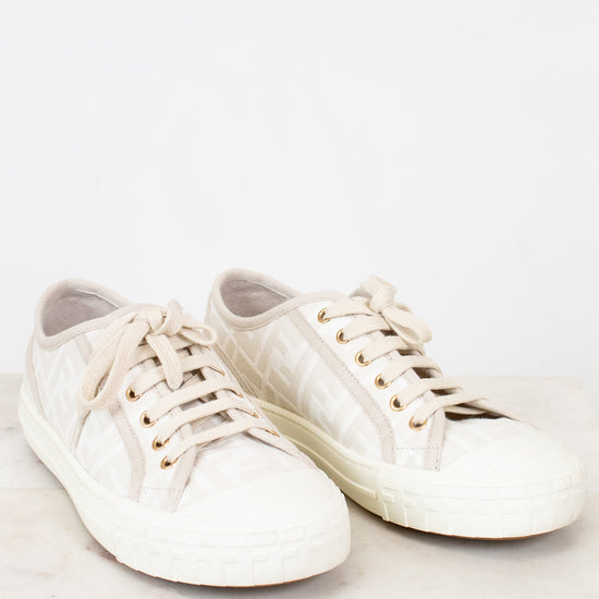 Pair of white sneakers on a light background