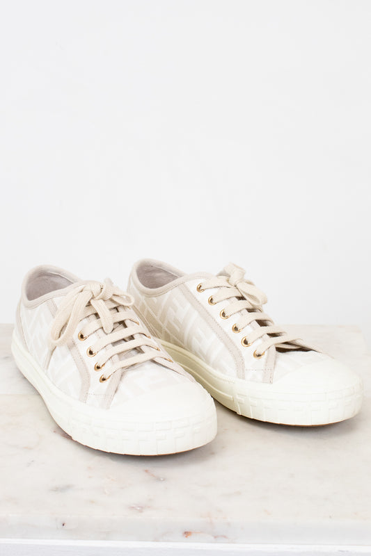 Pair of white sneakers on a light background