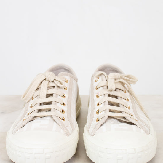 Pair of white sneakers on a light gray background