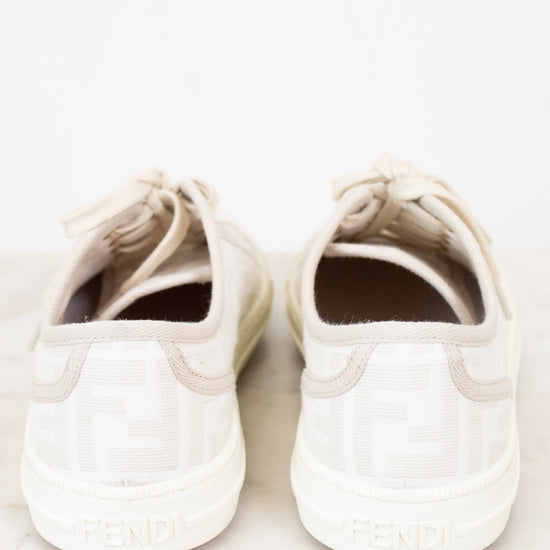 Pair of white sneakers on a light marble surface