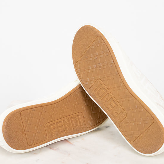 Tan shoe insoles with 'Fendi' branding on a white background