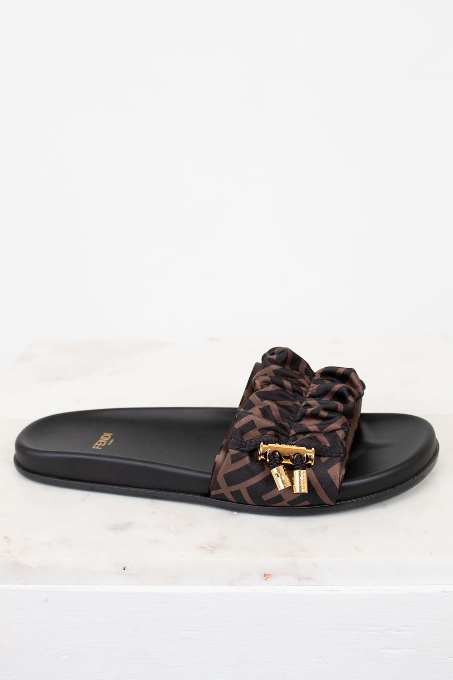 Zucca print sandal with a black slide on a white background