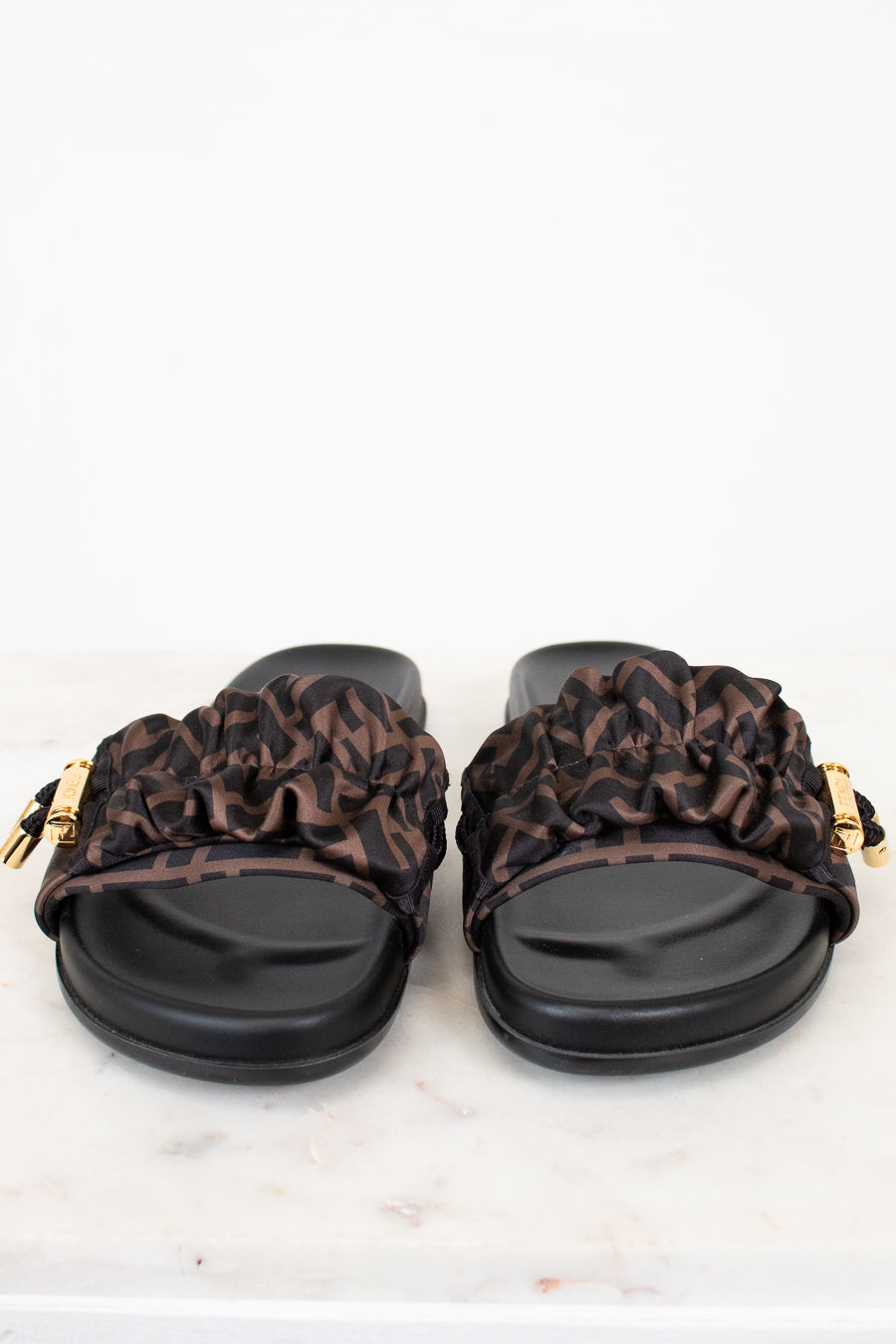 Pair of sandals with Zucca print straps on a white background