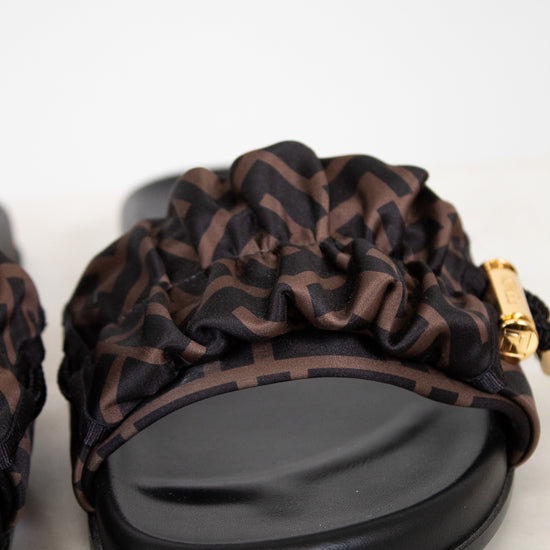 Black and brown patterned sandal on a white background