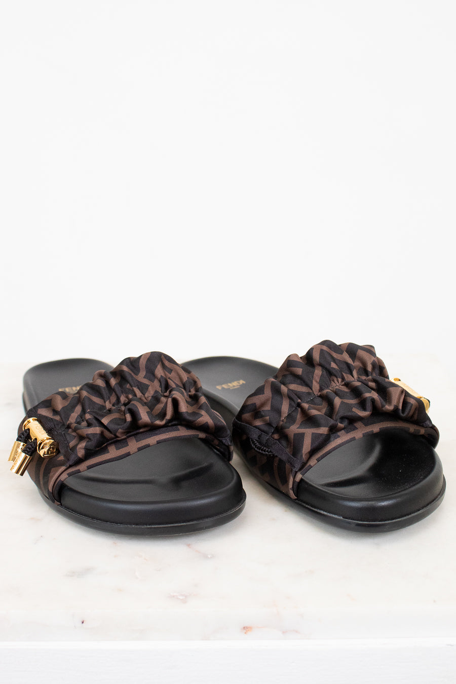 Pair of sandals with zucca print straps on a white background