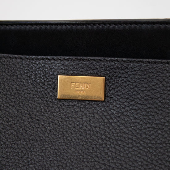 Black handbag with a gold Fendi logo on a white background