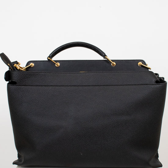 Black handbag with gold accents on a white background