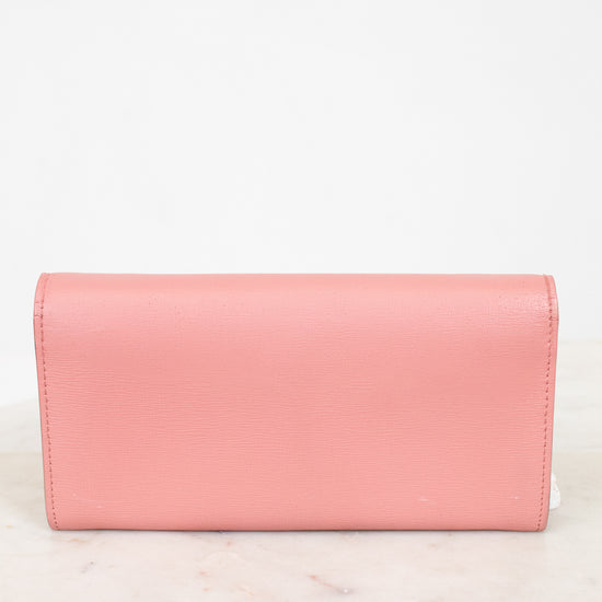 Pink back of wallet on a marble surface