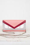Pink and silver clutch bag with a chain strap on a white background