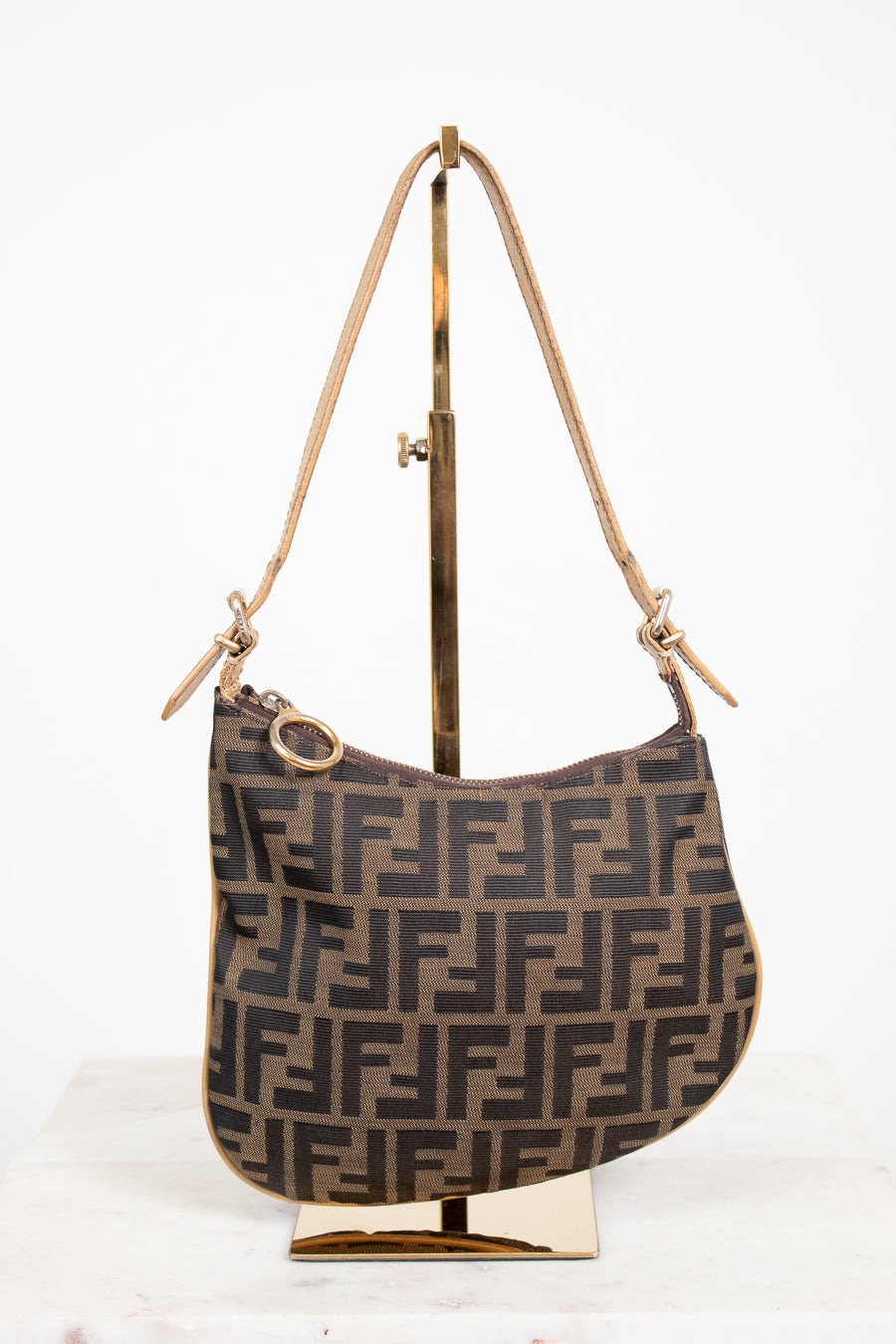Designer handbag with a distinctive pattern on a white background