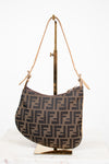 Designer handbag with a distinctive pattern on a stand against a white background