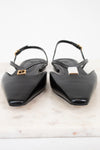 A pair of black leather pointed-toe slingback flats with gold-tone Fendi logo hardware, displayed on a white marble surface against a white background.
