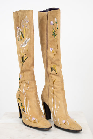 Beige knee-high boots with floral embroidery on a white background