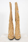 Tan boots with floral embroidery on a white background