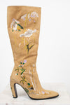 Beige knee-high boot with floral embroidery on a white background