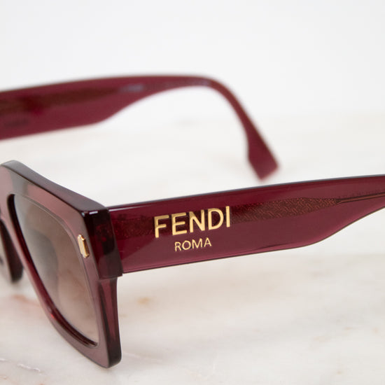 Fendi sunglasses with gold logo on a light background