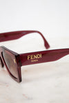 Fendi sunglasses with gold logo on a light background