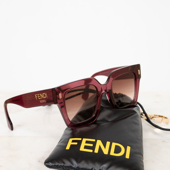 Fendi sunglasses with a black pouch on a white background