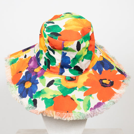 Colorful floral bucket hat with fringe on a white background