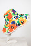 Colorful floral bucket hat on a white stand against a white background