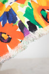 Colorful floral patterned bucket hat with tassels on a white background