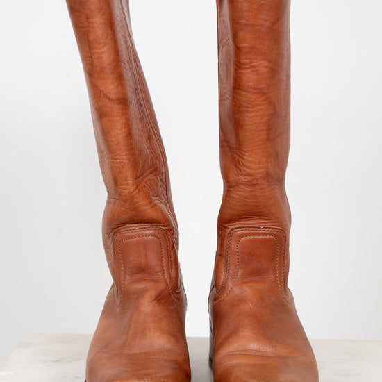 Pair of brown leather boots on a white background