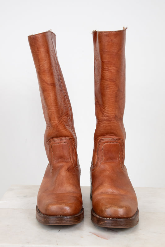 Pair of brown leather boots on a white background