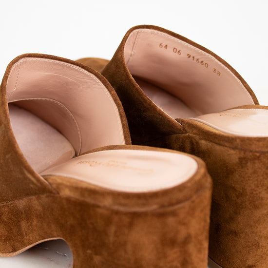 Brown suede shoes on a marble surface